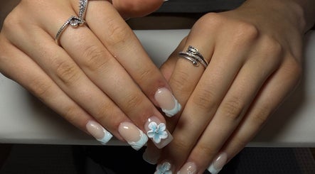 Elegant floral nail art at The Beauty Lounge, Swindon, England, GB, showcasing intricate blue designs.