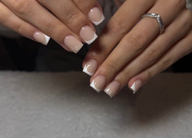 Elegant French manicure at The Beauty Lounge, Swindon, England, GB showcasing glossy nail finish.