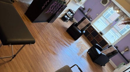 Relaxing spa area at Hair HQ Ilkeston, Ilkeston, England, GB with massage table and chairs in serene setting.