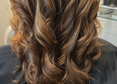Elegant wavy hairstyle at Kalos Hair Design in Asheville, North Carolina, US showcasing rich brown tones.