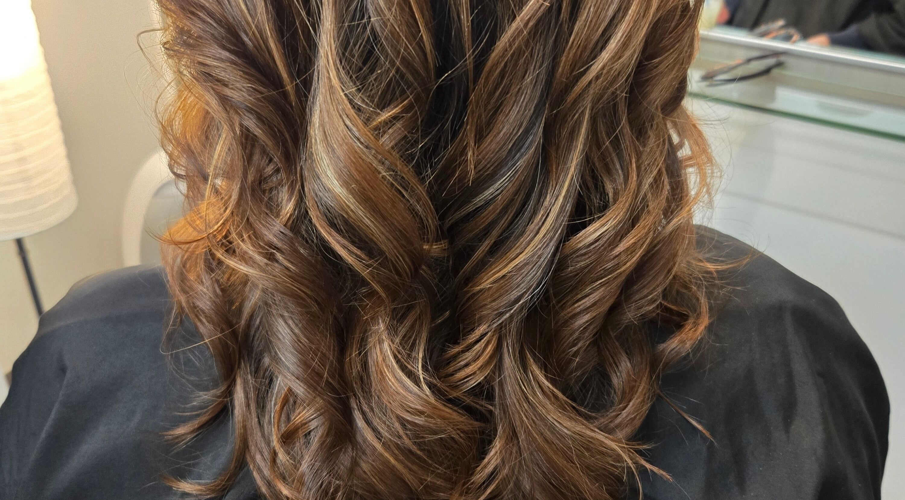 Elegant wavy hairstyle at Kalos Hair Design in Asheville, North Carolina, US showcasing rich brown tones.