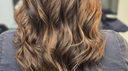 Elegant, wavy hairstyle at Kalos Hair Design, Asheville, North Carolina, US. Perfect for showcasing vibrant highlights.