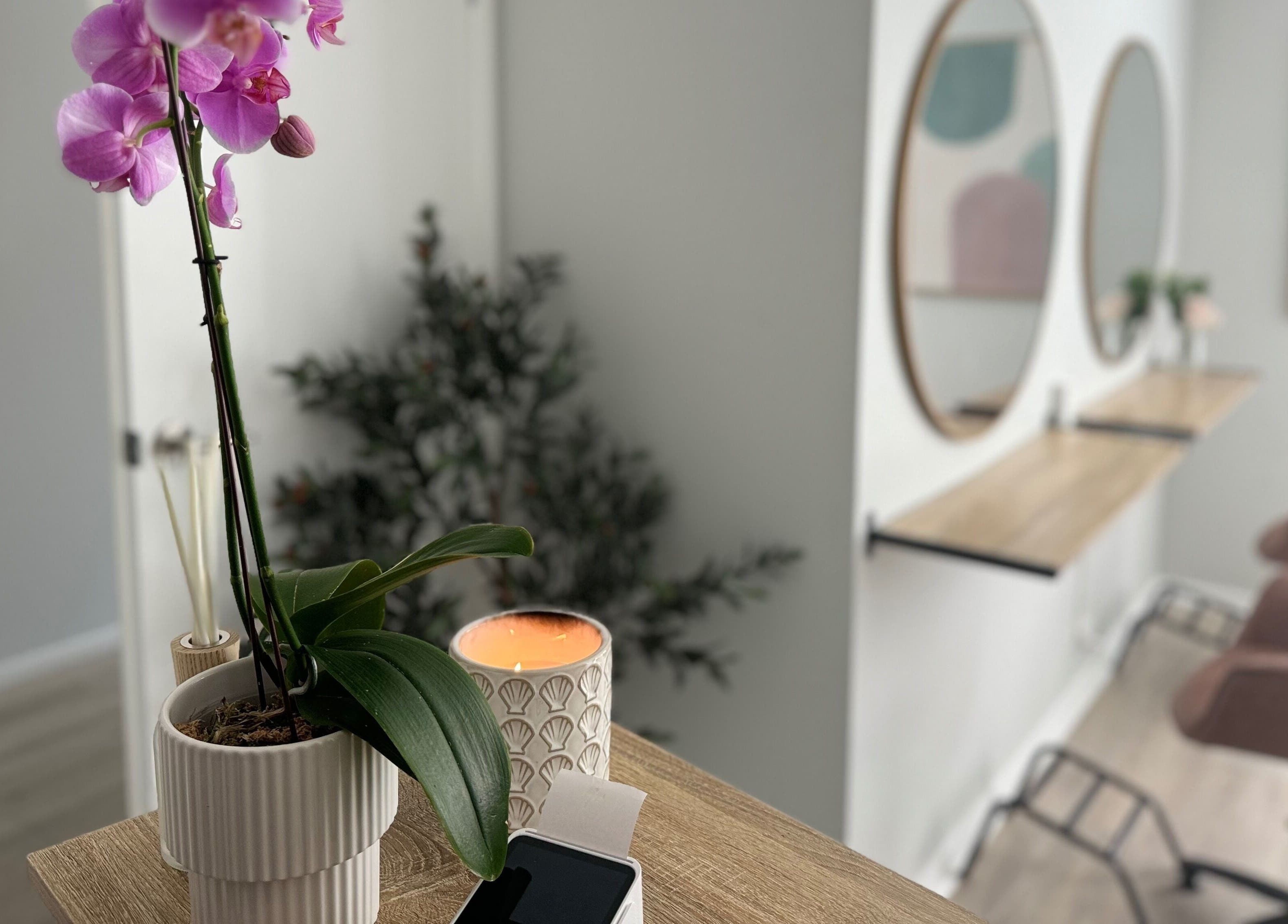 Elegant interior of Studio 12 - Hair By Fiona in Thornlands, Queensland, AU with orchids and stylish decor.