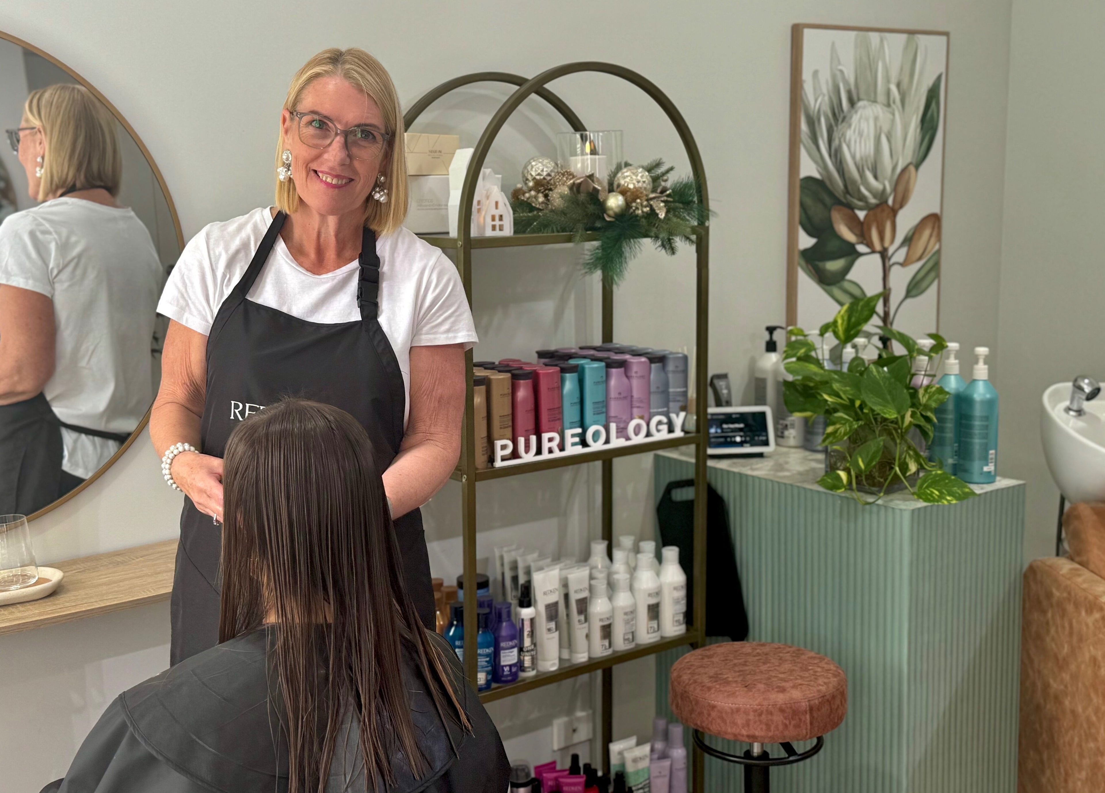 Stylist at Studio 12 - Hair By Fiona in Thornlands, Queensland, AU working with a client in a modern salon setting.