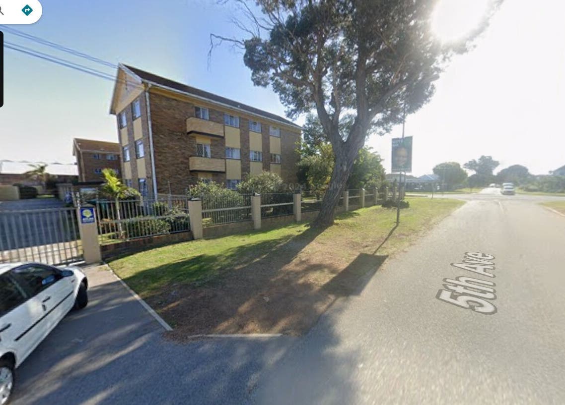 Street view of Arketa Parlour, Gqeberha, Eastern Cape, ZA with a sunny sky and nearby buildings.