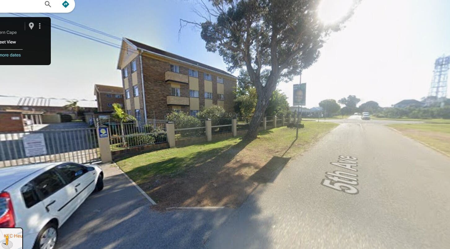 Street view of Arketa Parlour, Gqeberha, Eastern Cape, ZA with a sunny sky and nearby buildings.