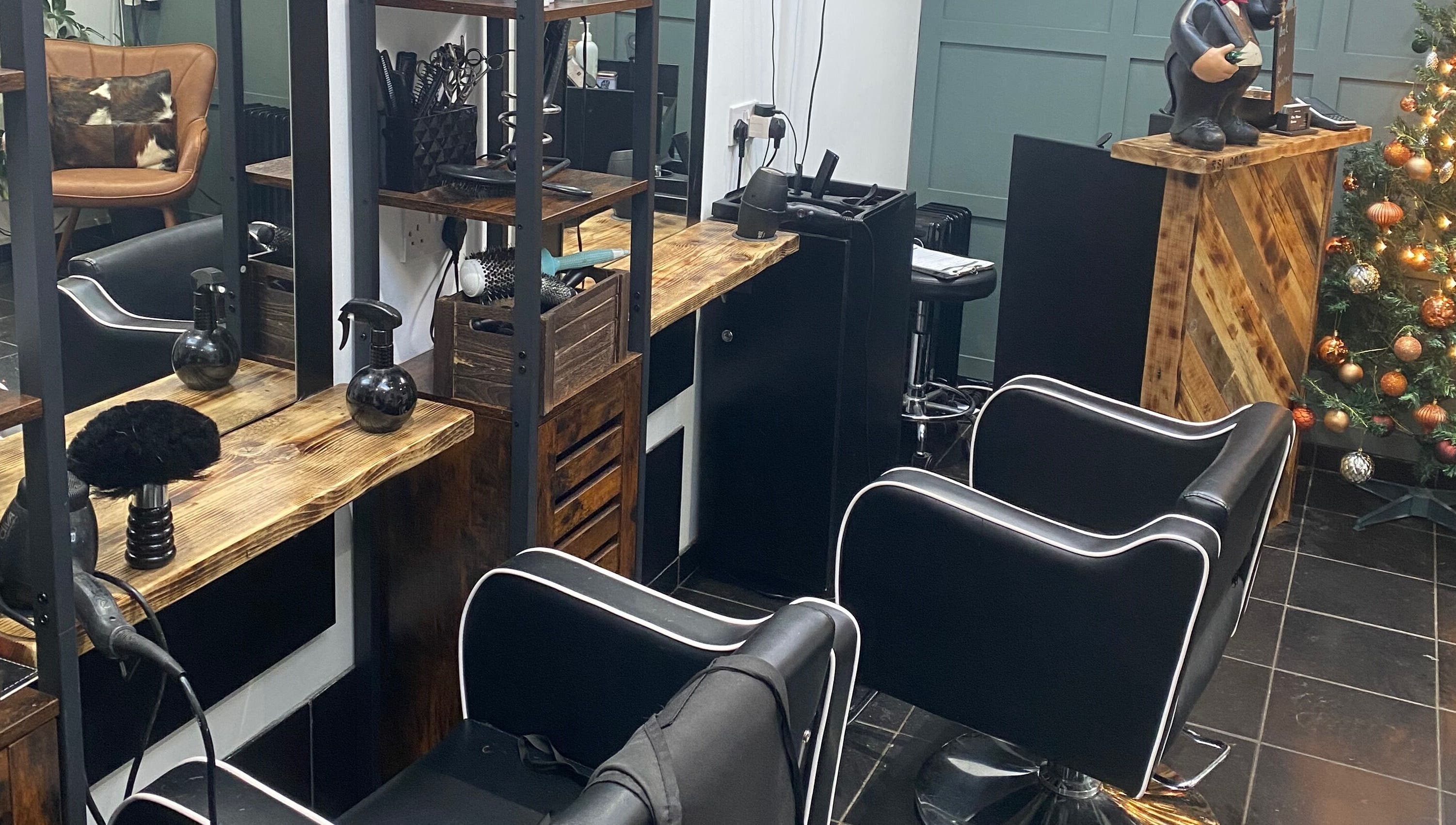 Cozy salon interior at The Mane Room, Cookham, England, GB, featuring stylish chairs and unique decor.