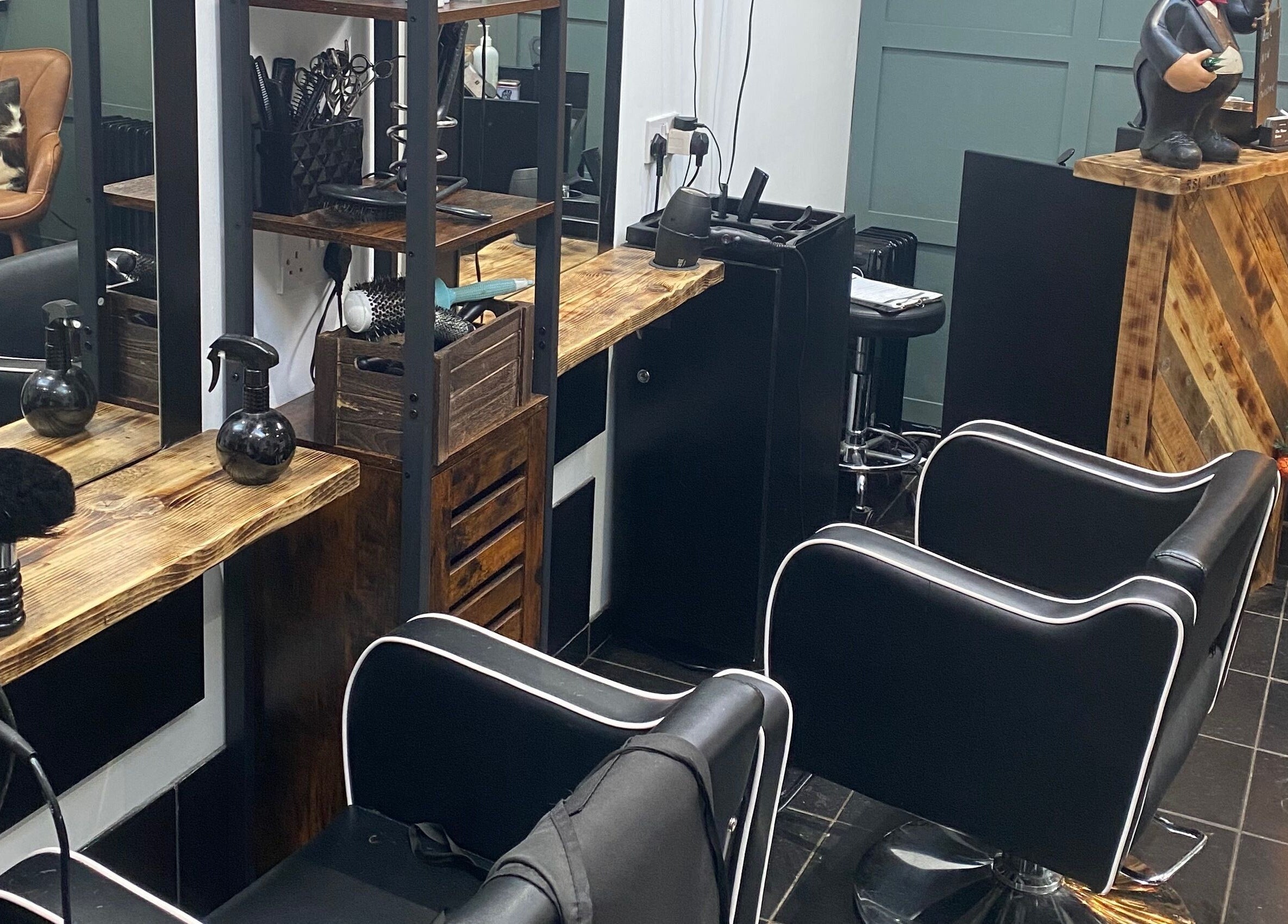Cozy salon interior at The Mane Room, Cookham, England, GB, featuring stylish chairs and unique decor.