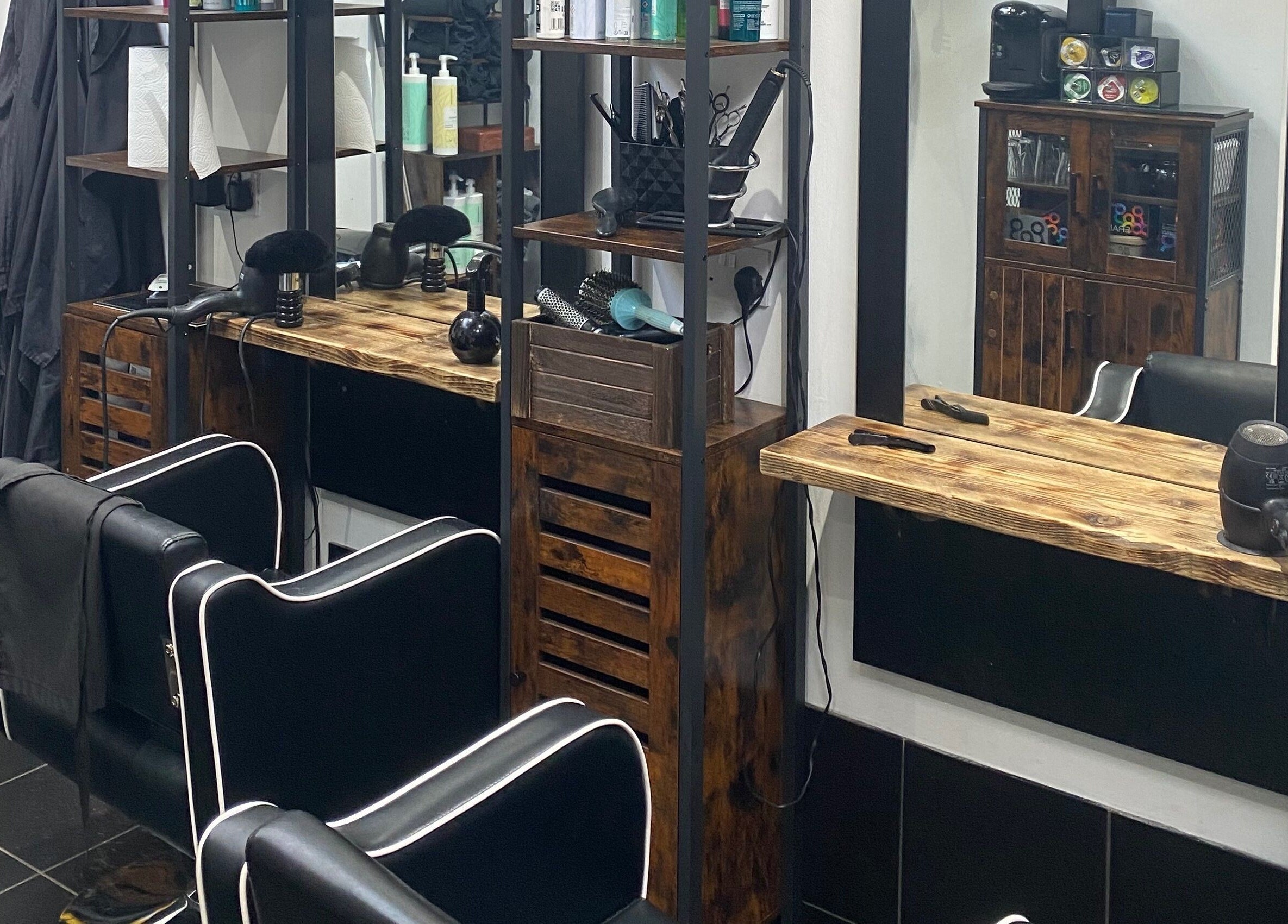 Modern salon station at The Mane Room, Cookham, England, GB featuring stylish chairs and wooden decor.