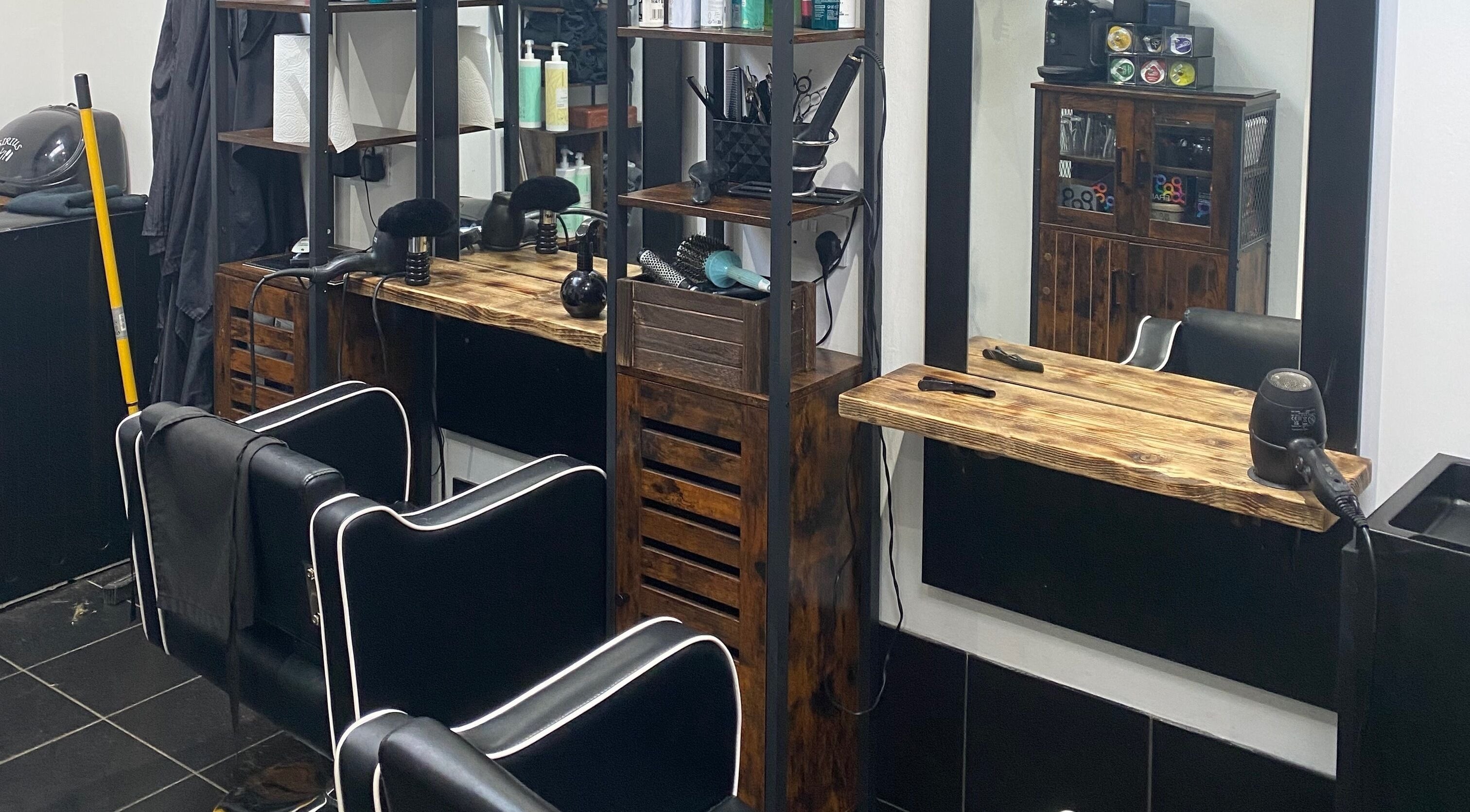 Modern salon station at The Mane Room, Cookham, England, GB featuring stylish chairs and wooden decor.