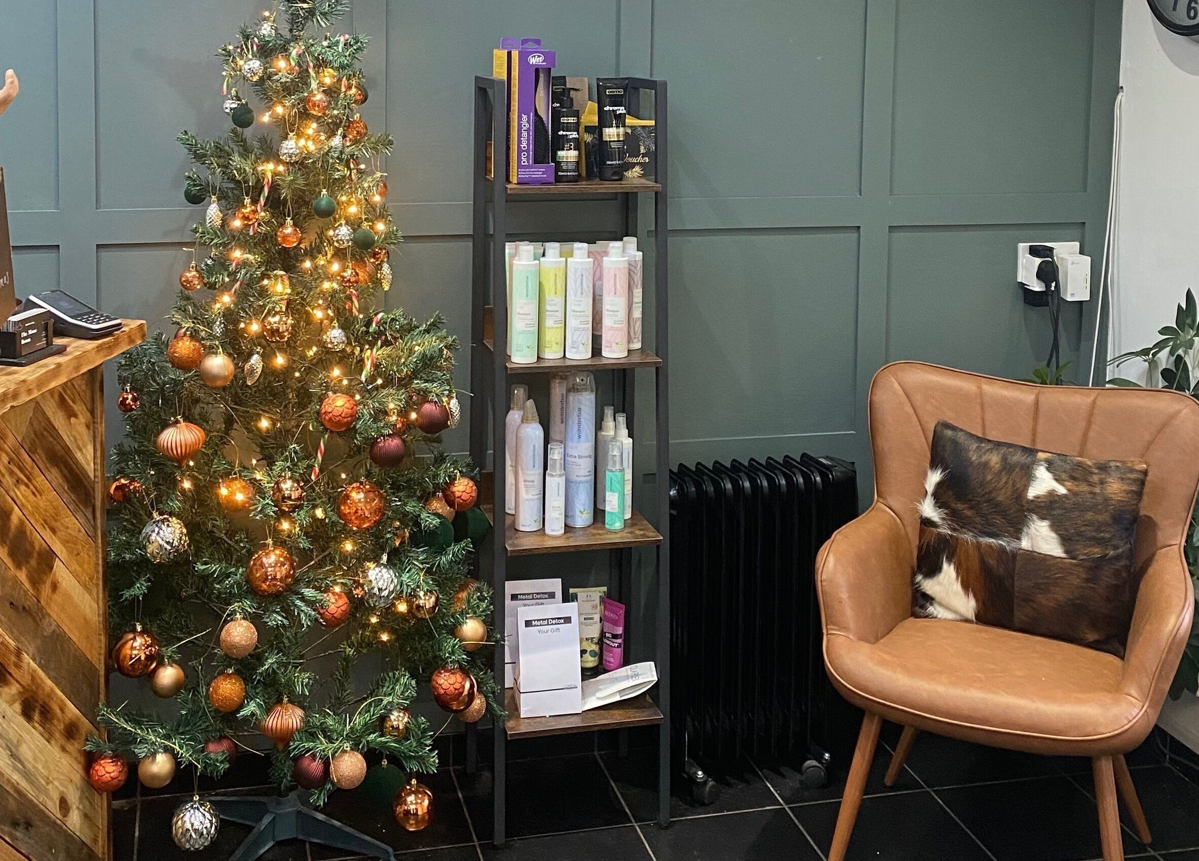 Festive corner at The Mane Room, Cookham, England, GB with Christmas tree, chair, and products on display.