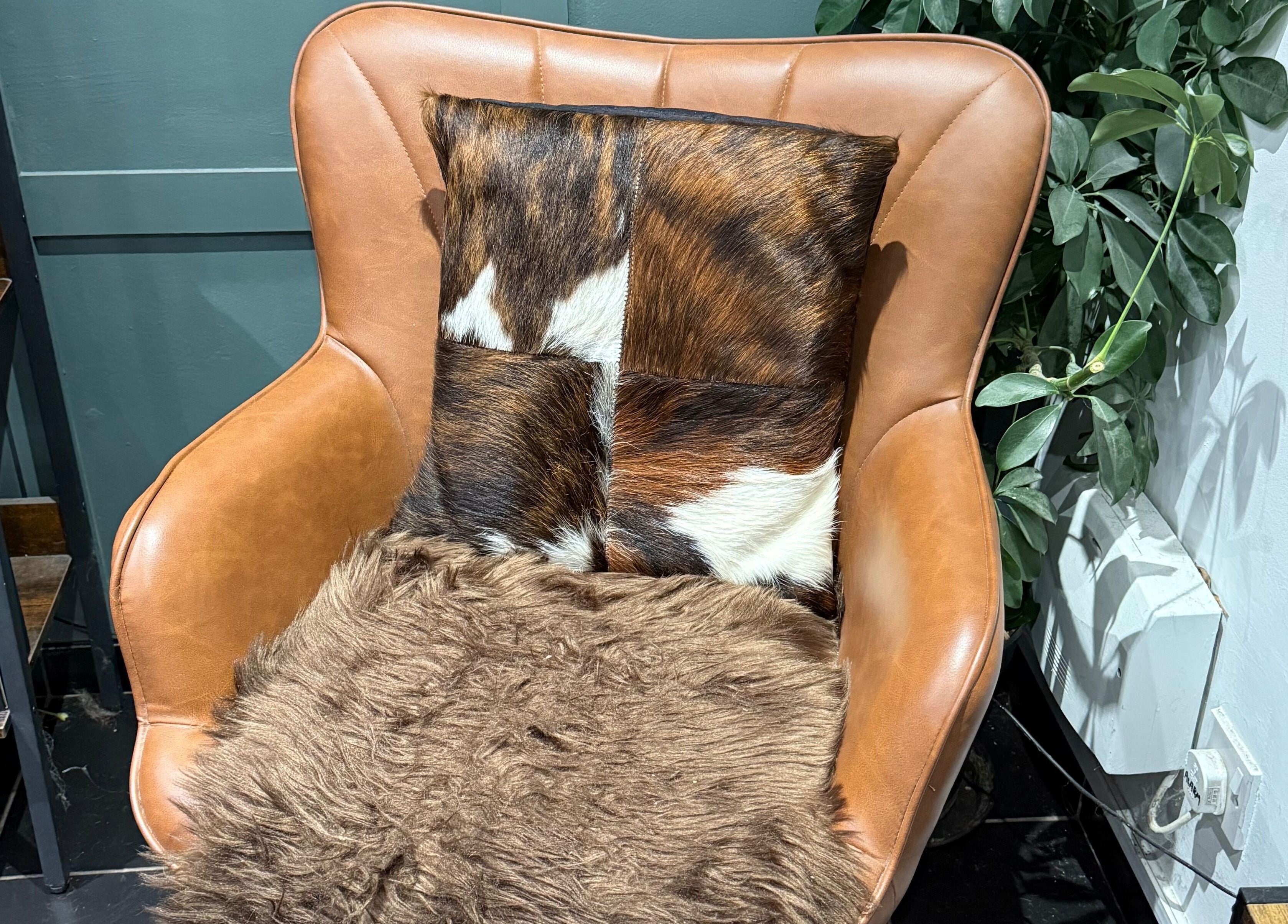 Luxurious brown leather chair with fur accents at The Mane Room, Cookham, England, GB.