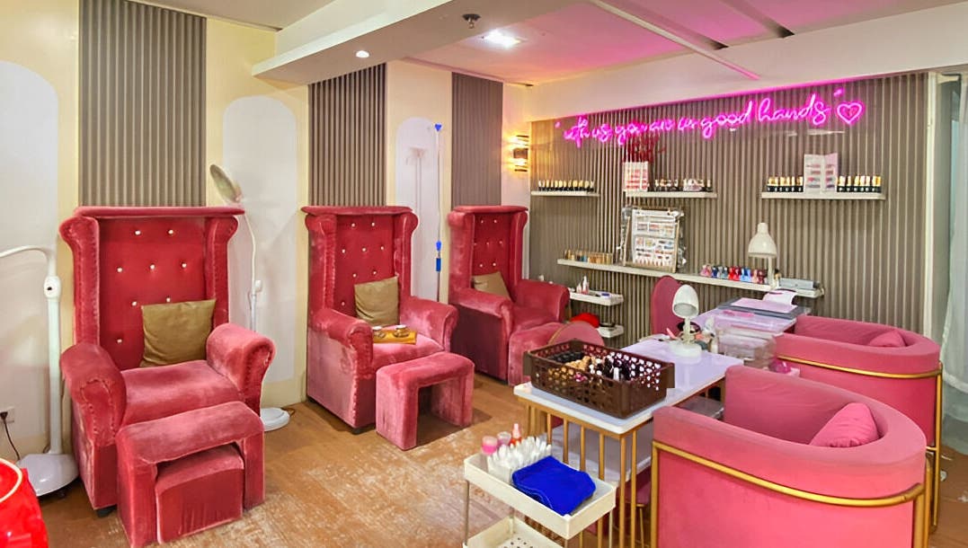 Luxurious red velvet chairs at Daily Lounge Salon, Makati, Metro Manila, PH, offering a relaxing ambiance.