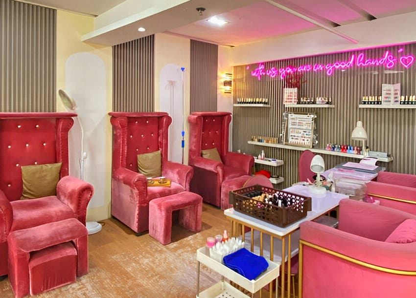 Luxurious red velvet chairs at Daily Lounge Salon, Makati, Metro Manila, PH, offering a relaxing ambiance.