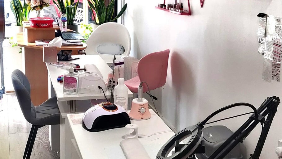 Naiyah Nails salon interior in London, England, GB, featuring modern nail stations and seating.