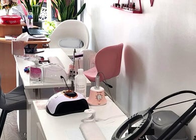 Naiyah Nails salon interior in London, England, GB, featuring modern nail stations and seating.