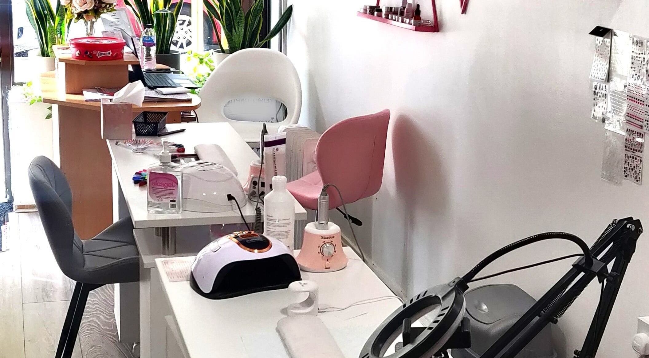 Naiyah Nails salon interior in London, England, GB, featuring modern nail stations and seating.