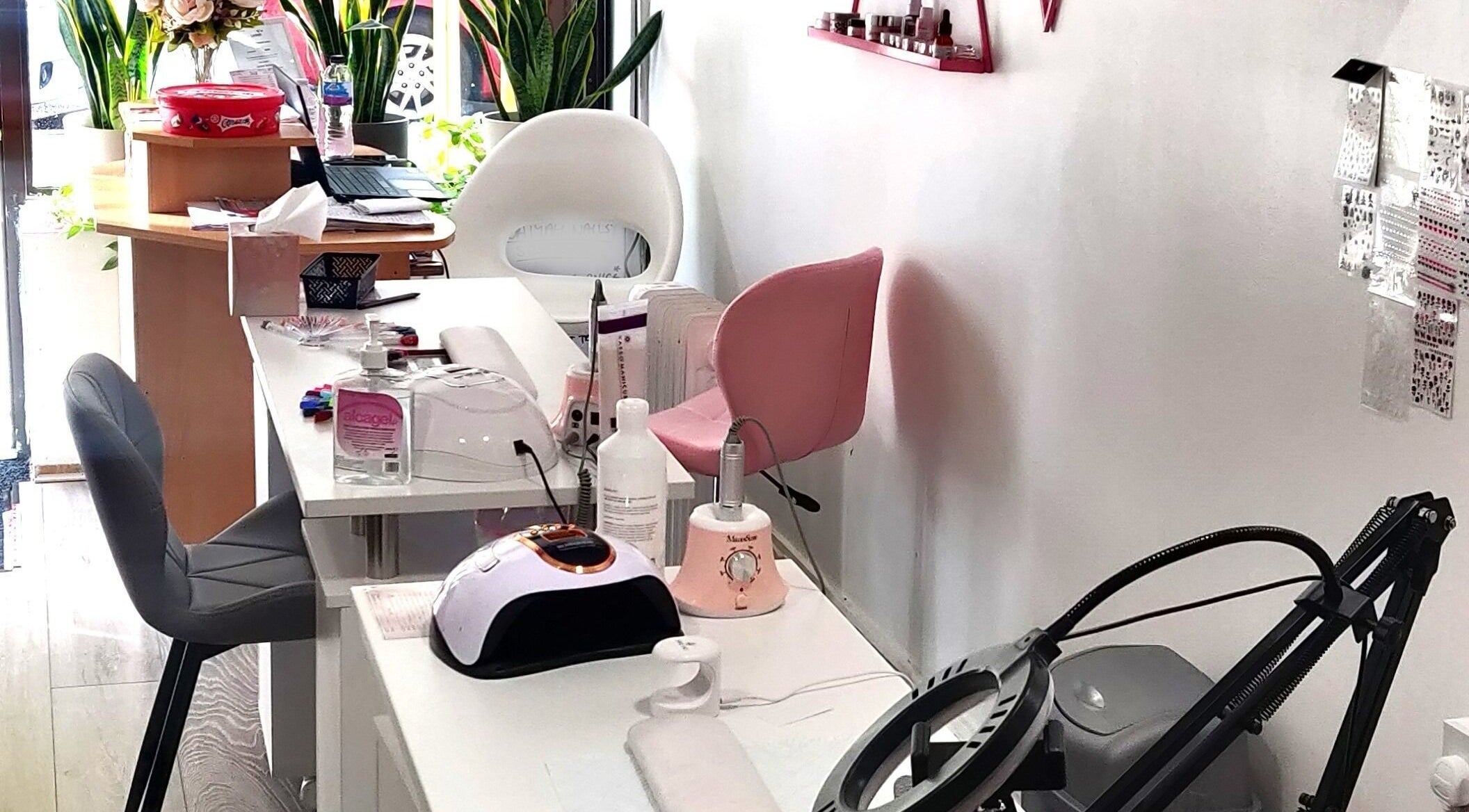 Naiyah Nails salon interior in London, England, GB, featuring modern nail stations and seating.