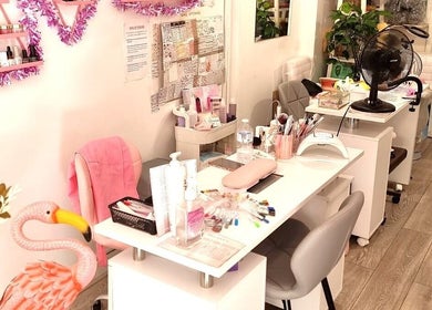 Cozy nail studio at Naiyah Nails in London, England, GB, showcasing elegant pink decor and manicure stations.