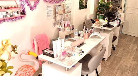Cozy nail studio at Naiyah Nails in London, England, GB, showcasing elegant pink decor and manicure stations.