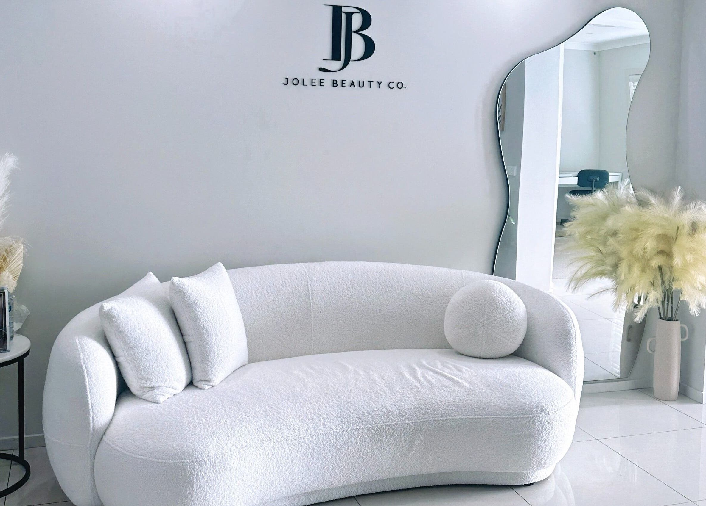 Luxury lounge area at Jolee Beauty Co - Prestons, Prestons, New South Wales, AU with stylish decor and mirror.