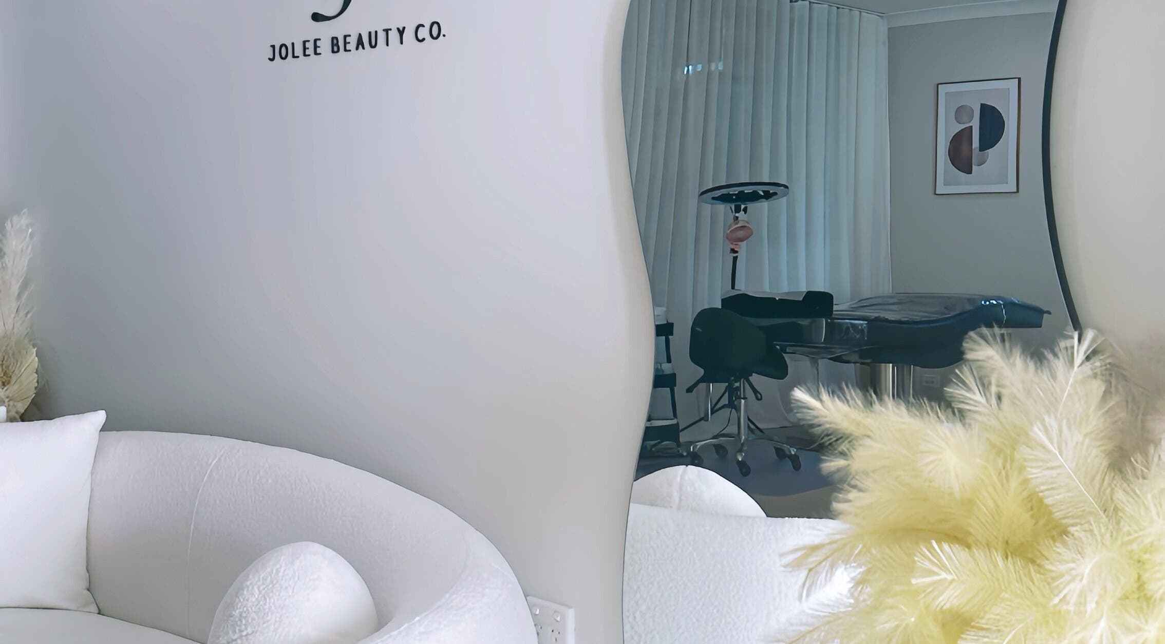 Elegant interior of Jolee Beauty Co - Prestons, featuring plush seating and modern decor in Prestons, New South Wales, AU.