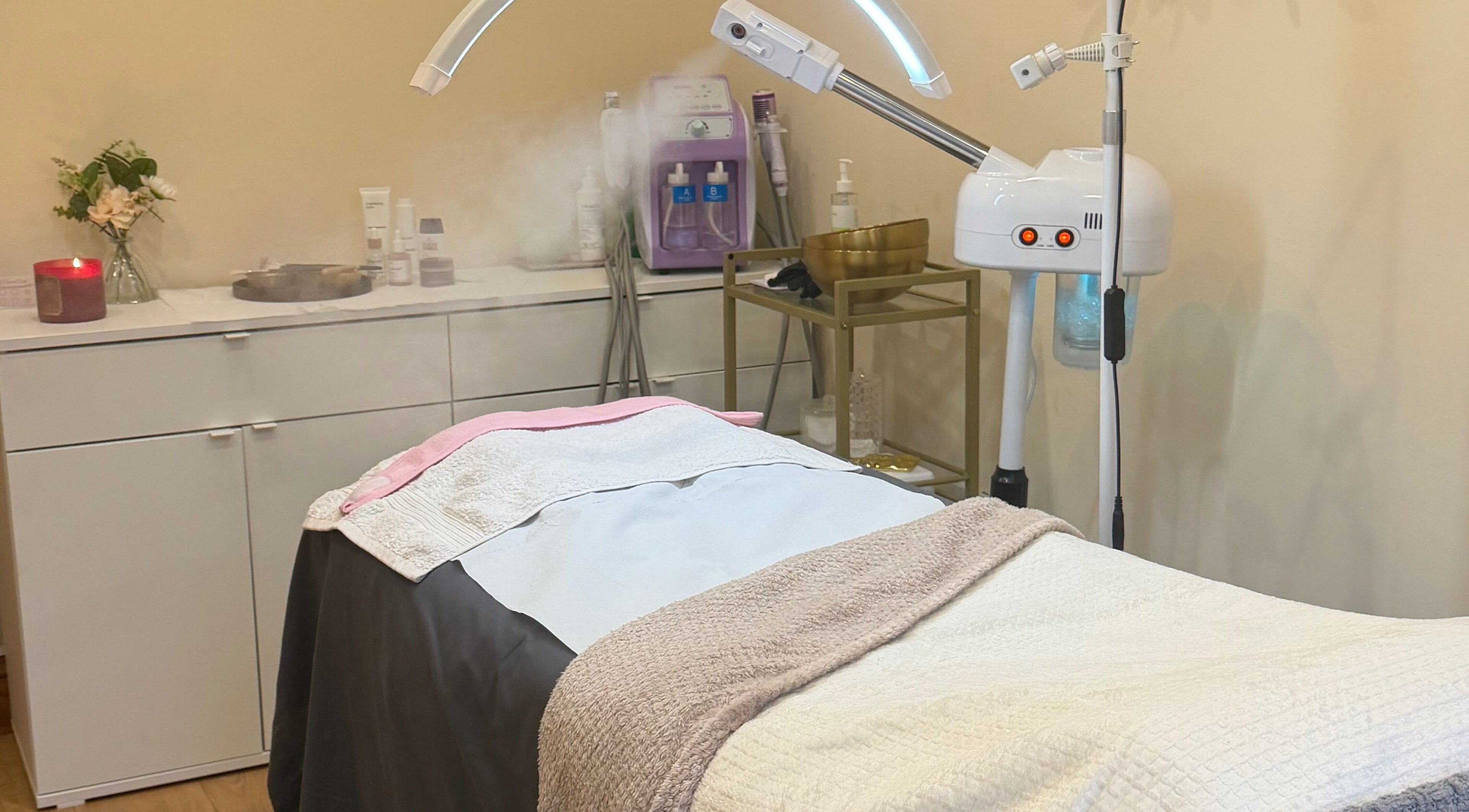 A serene treatment room at Zafirah Aesthetic Beauty, London, England, GB, with a massage table and equipment.