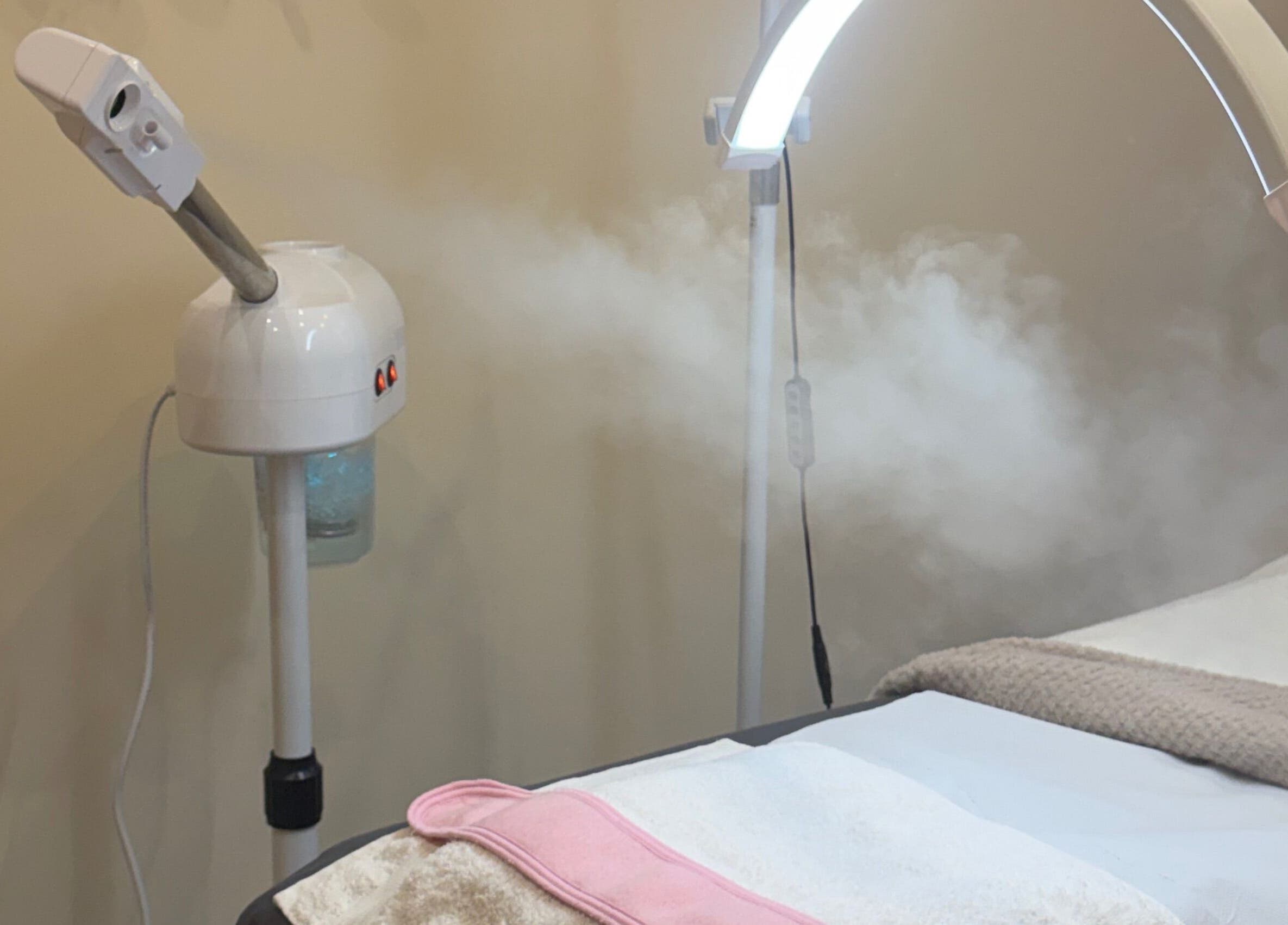 Facial steamer and treatment bed at Zafirah Aesthetic Beauty in London, England, GB, enhancing relaxation.