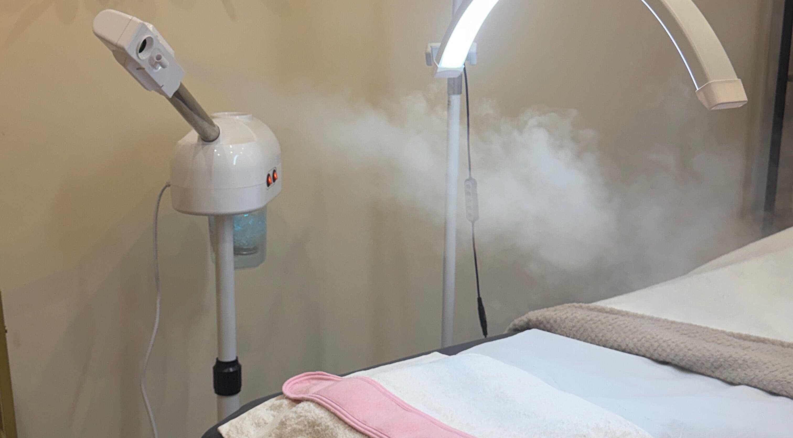 Facial steamer and treatment bed at Zafirah Aesthetic Beauty in London, England, GB, enhancing relaxation.