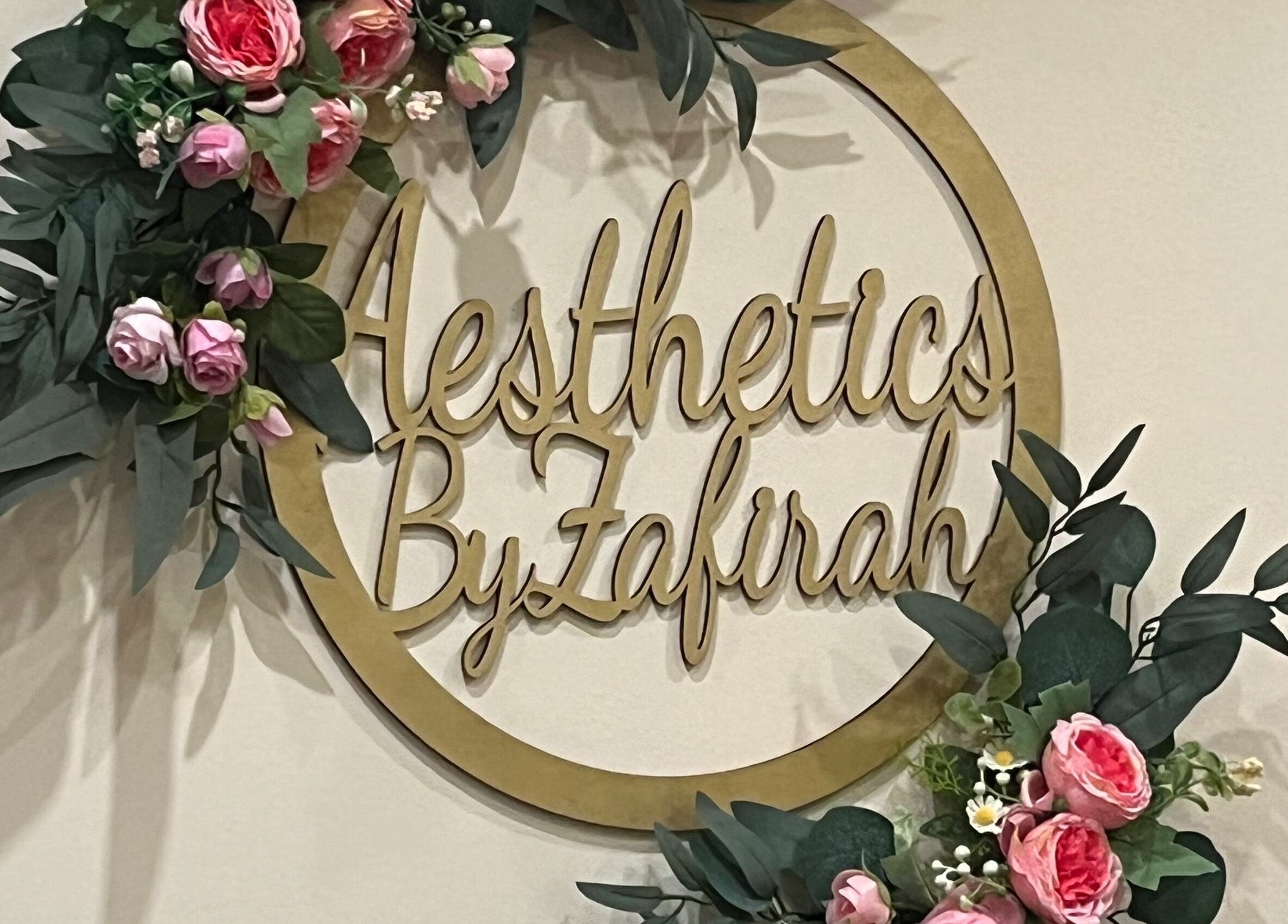 Elegant floral arrangement around Zafirah Aesthetic Beauty sign in London, England, GB.