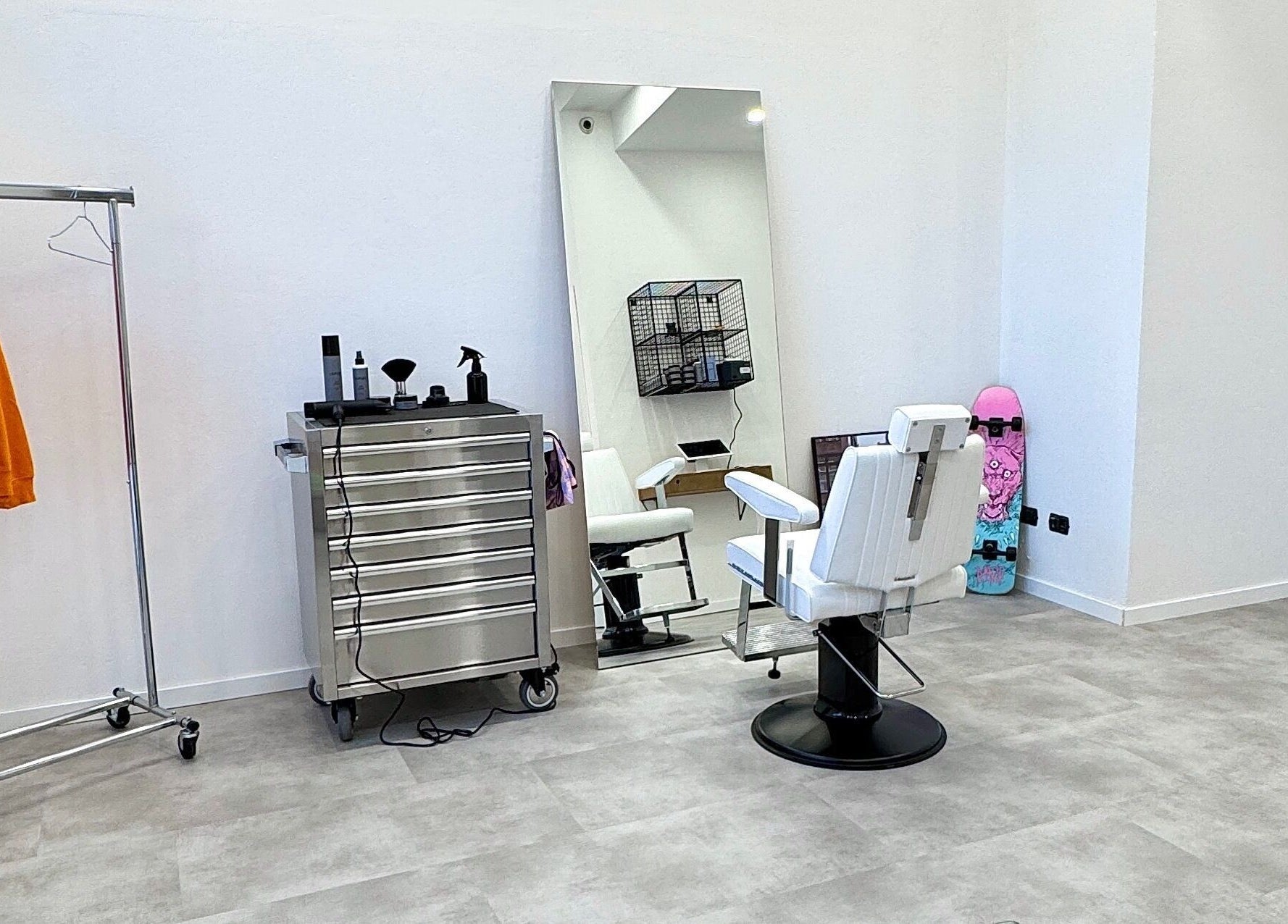 Interno moderno di ISPIRI STUDIO a Verona, Veneto, IT con poltrona bianca e specchio grande.