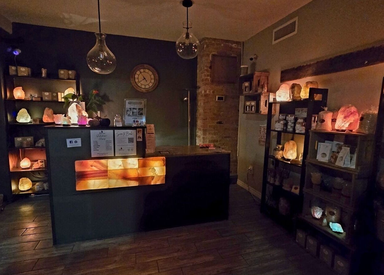 Cozy interior of Simply Salt Wellness & Salt Cave in Welland, Ontario, CA, featuring glowing salt lamps.