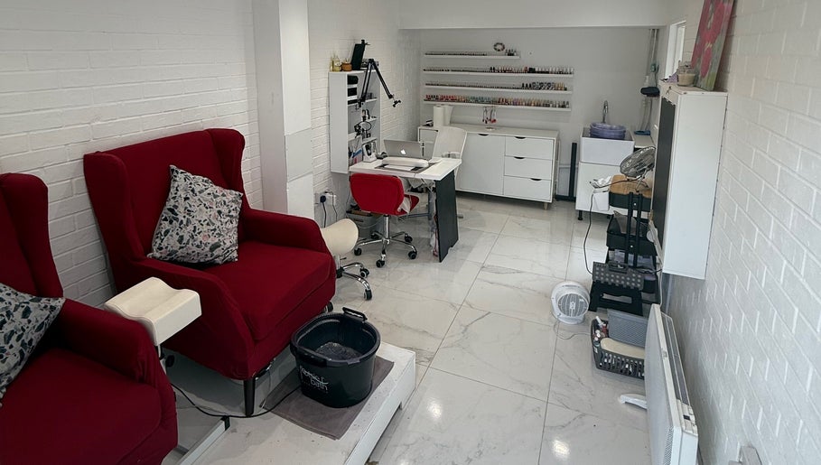 SENNUBIA beauty salon in London, England, GB with plush red chairs and a sleek workstation for treatments.