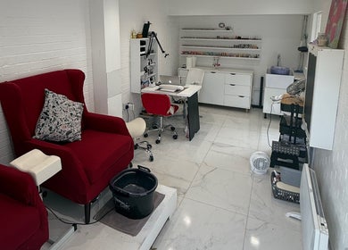 SENNUBIA beauty salon in London, England, GB with plush red chairs and a sleek workstation for treatments.
