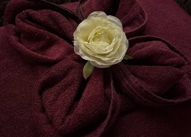 Luxurious burgundy towels with a white rose at Kamalaya Spa Zlatibor, Zlatibor, RS.