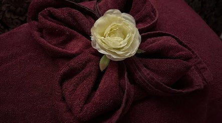 Luxurious red towel with rose at Kamalaya Spa Zlatibor, Zlatibor, RS, epitomizing elegance and relaxation.
