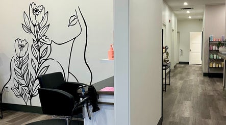 Chic salon interior at Xelia Hair & MediSpa, Moncton, New Brunswick, CA, featuring artistic wall design.