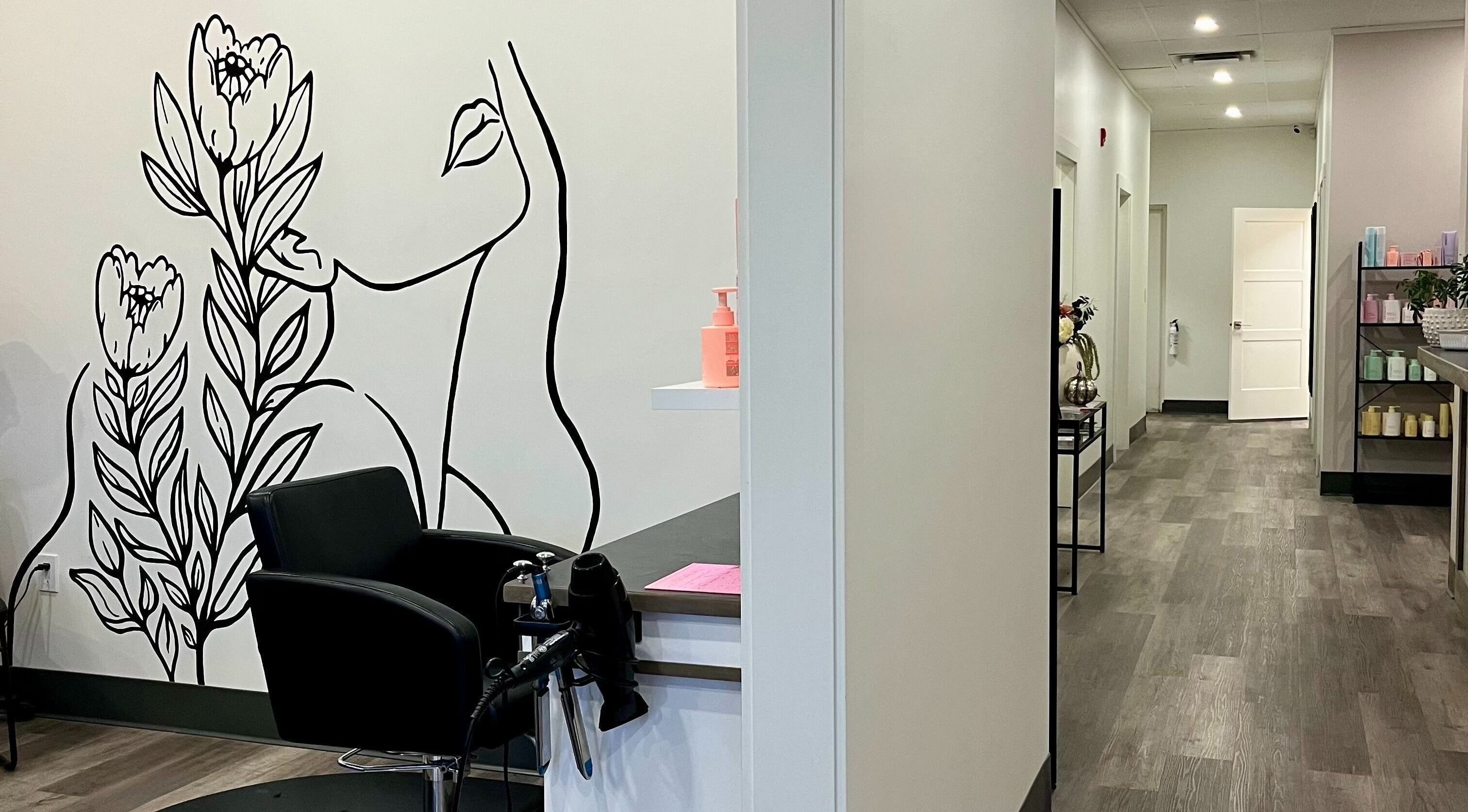 Chic salon interior at Xelia Hair & MediSpa, Moncton, New Brunswick, CA, featuring artistic wall design.