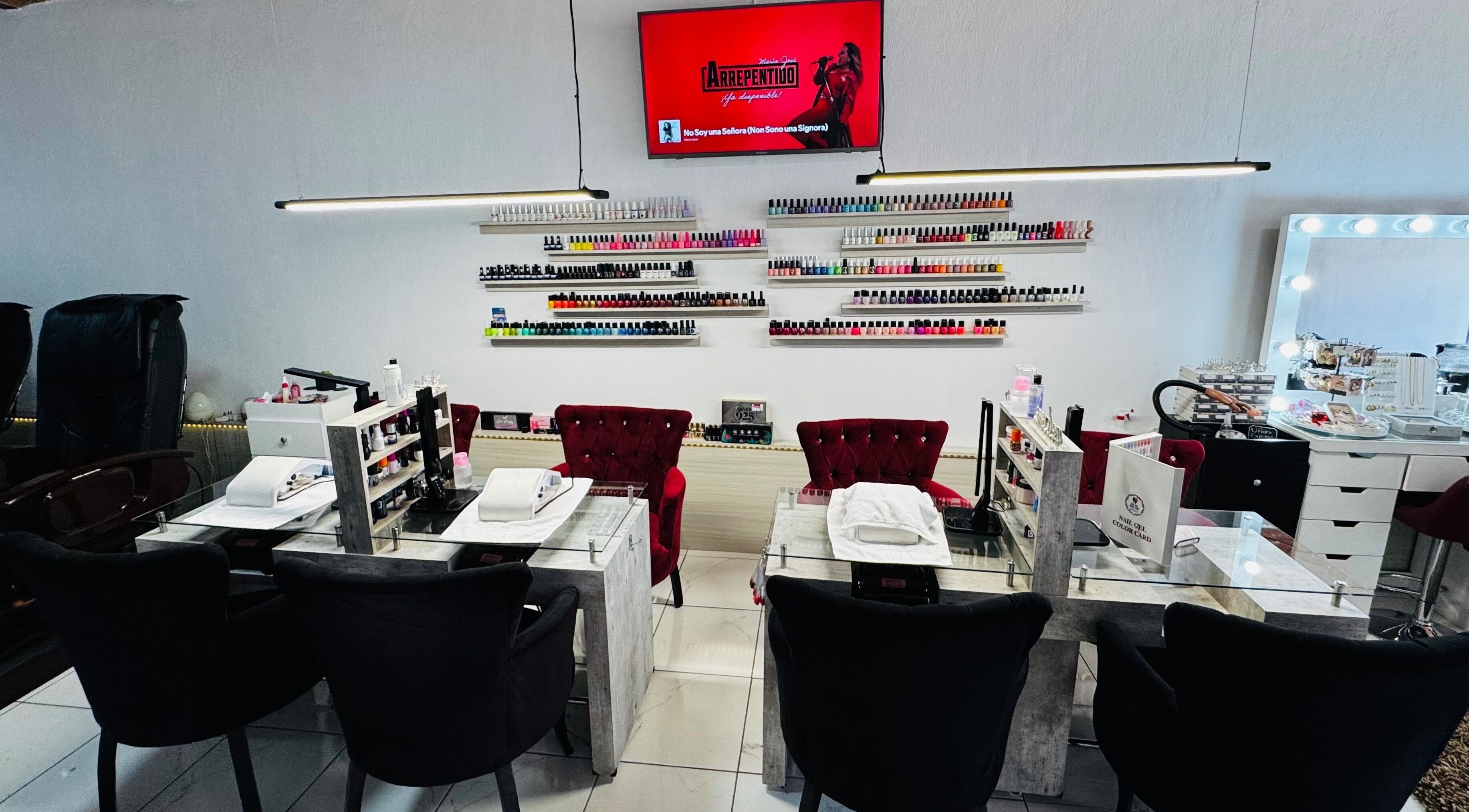 Elegant nail salon setup at Ajijic Nails Salón in Ajijic, Jalisco, MX, featuring manicured stations and vibrant polishes.
