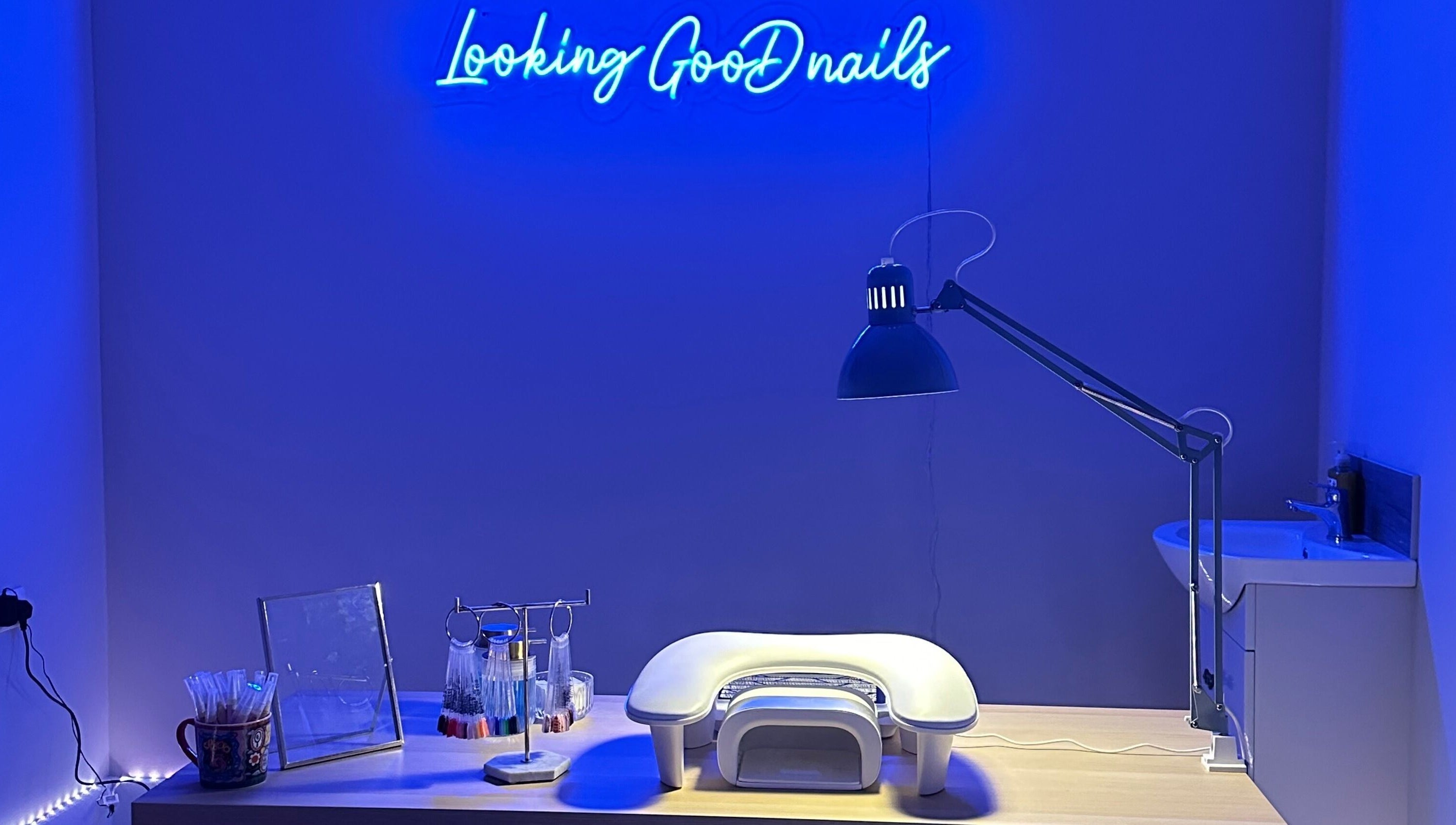 Modern nail station at LGD nails in Fareham, England, GB with blue neon lights and manicure tools.