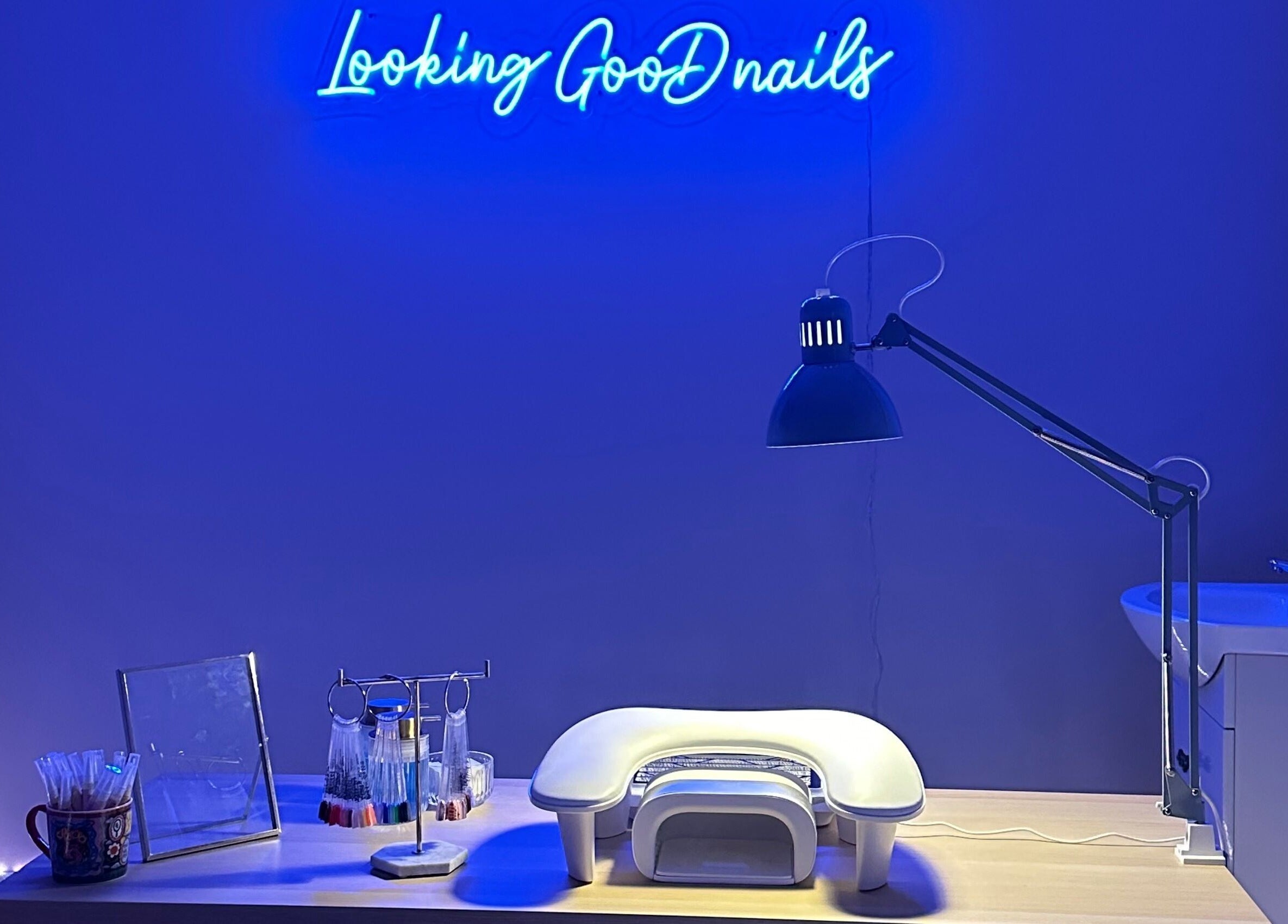 Modern nail station at LGD nails in Fareham, England, GB with blue neon lights and manicure tools.
