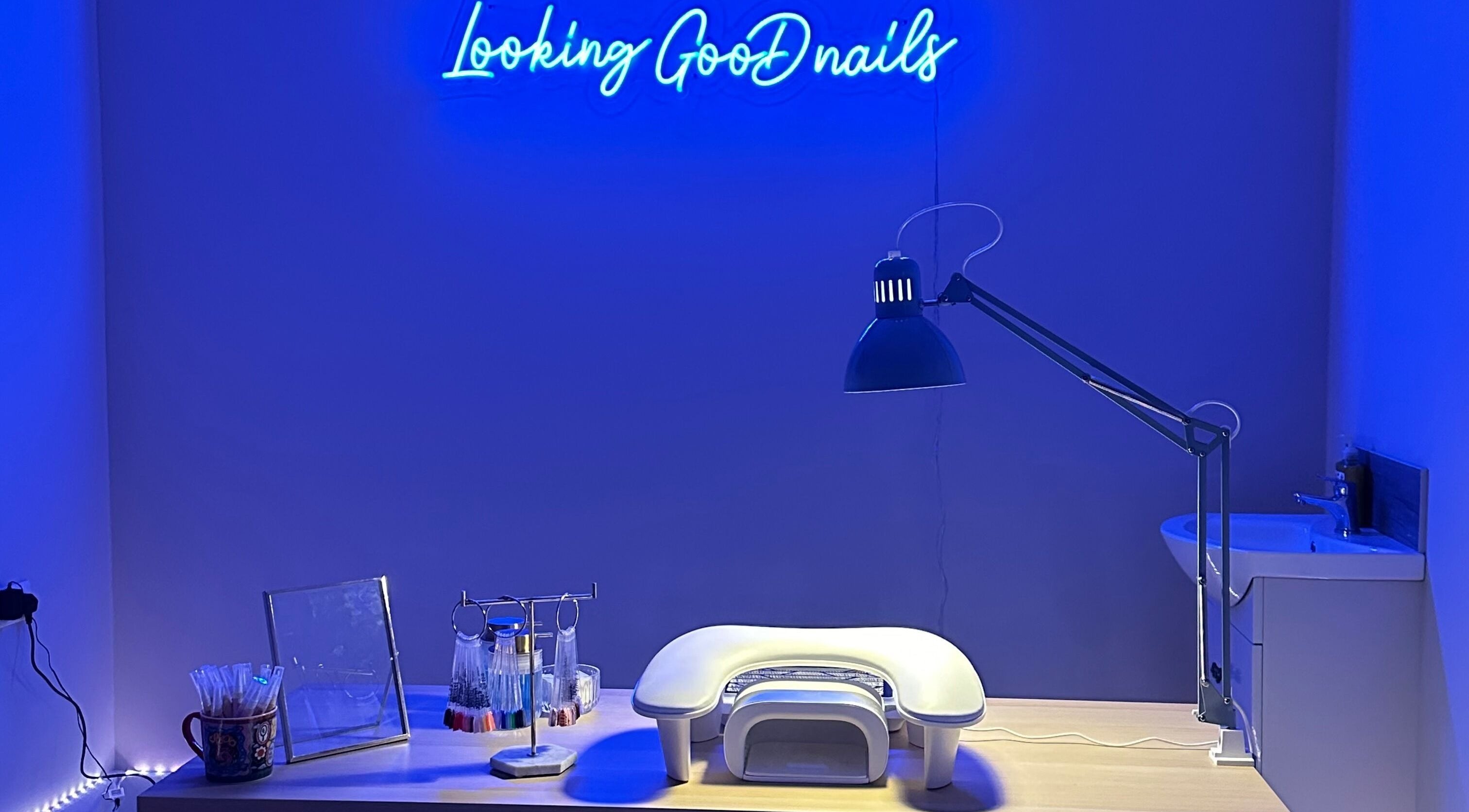 Modern nail station at LGD nails in Fareham, England, GB with blue neon lights and manicure tools.