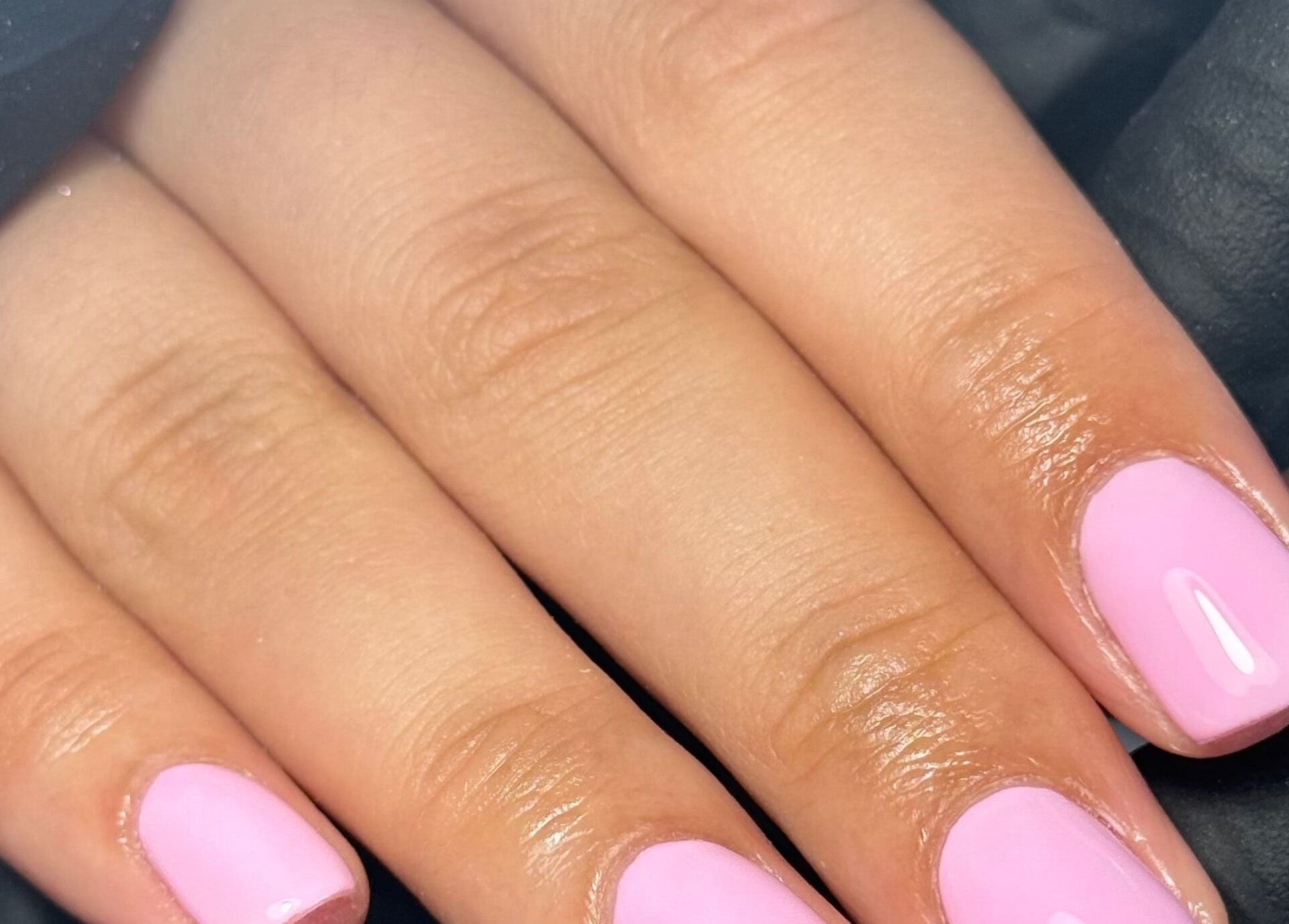 Elegant pink manicure at LGD nails, Fareham, England, GB showcasing neat design and glossy finish.