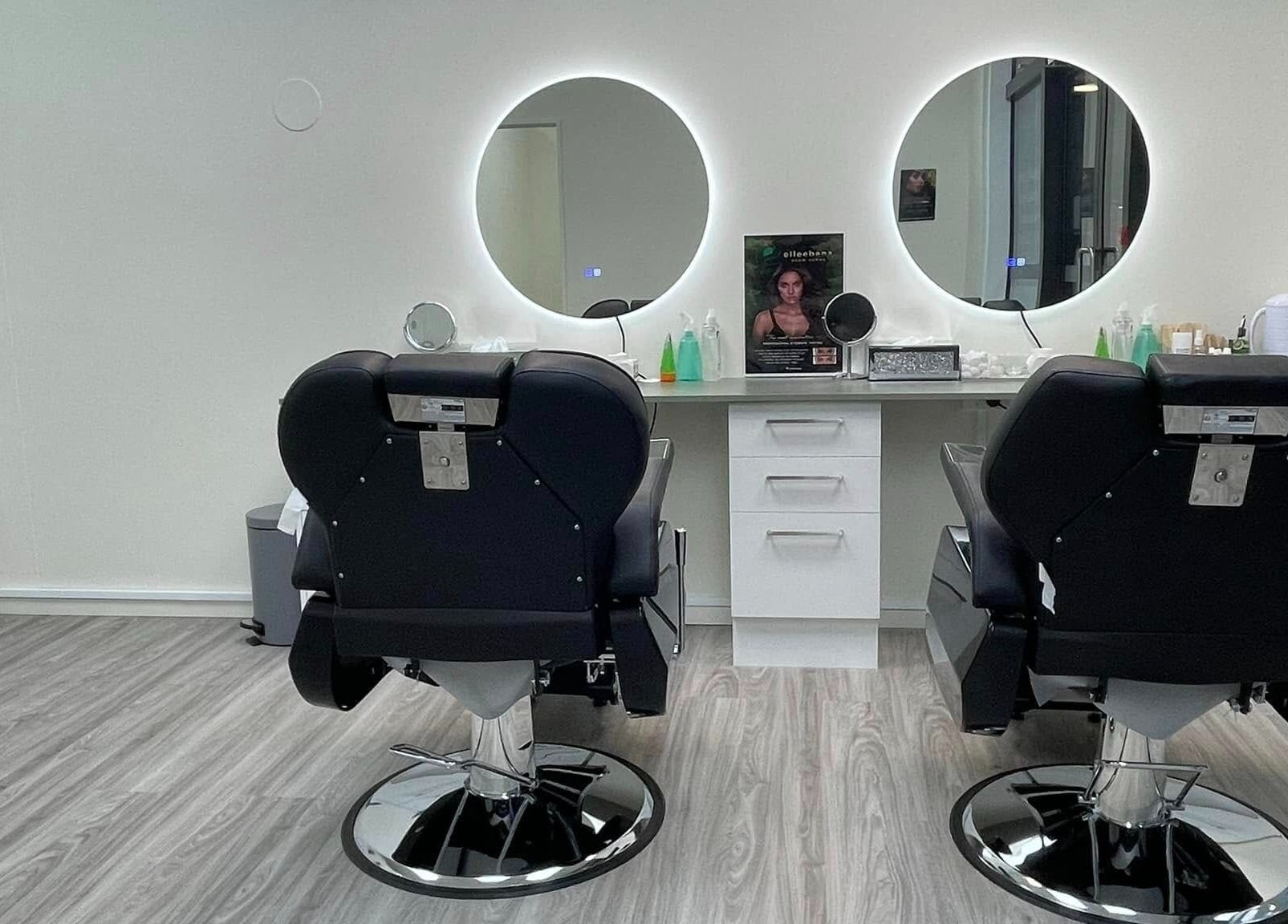 Modern salon interior at Enhance Beauty And Brows in Rolleston, Canterbury, NZ with two styling chairs.