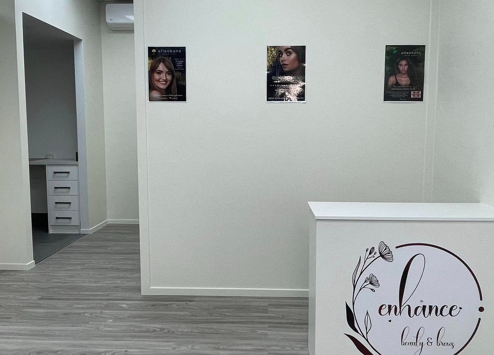 Reception area at Enhance Beauty And Brows, Rolleston, Canterbury, NZ with stylish decor and logo.