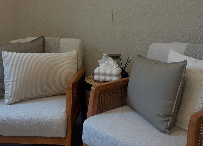 Relaxing seating area at Structure Beauty, Pickering, England, GB featuring plush cushions and elegant decor.