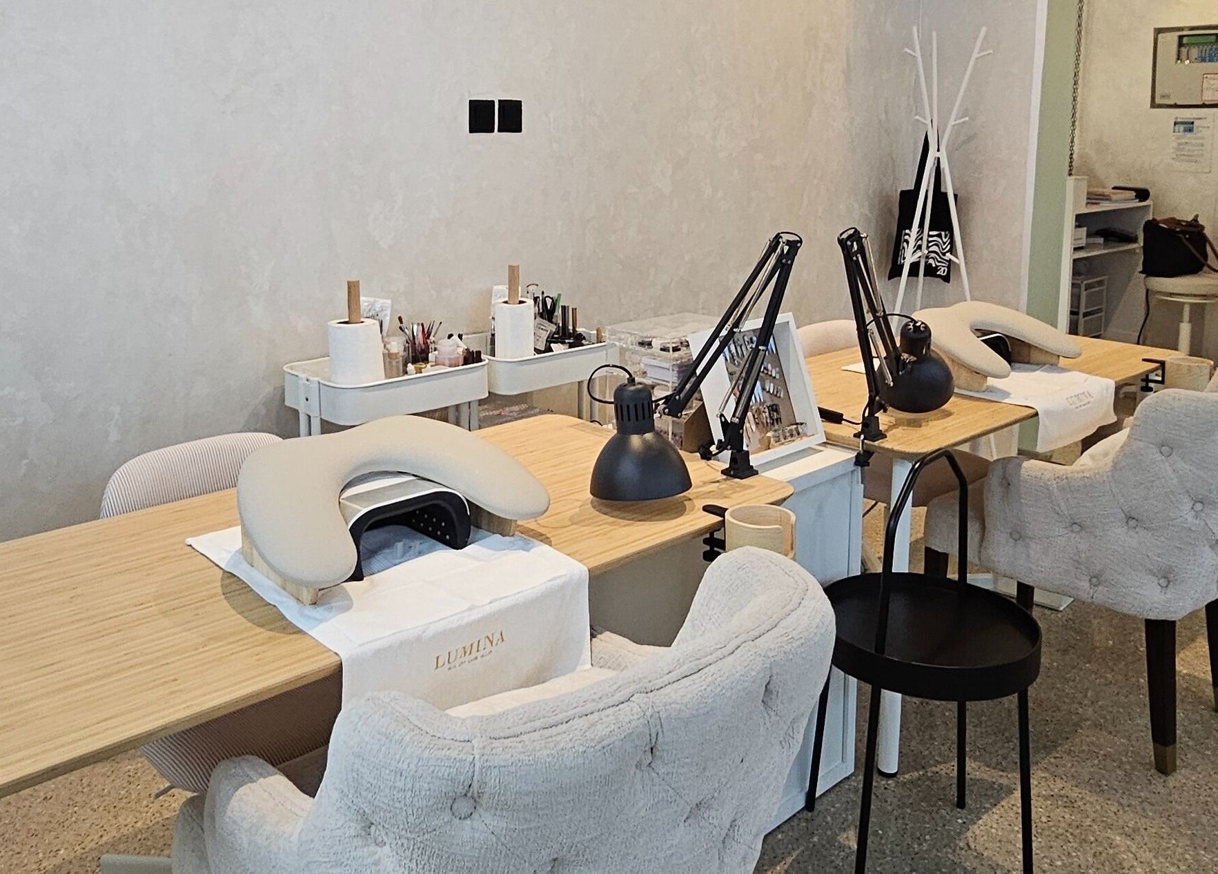 Chic manicure station at Lumina Nail & Lash Salon, الدوحة, بلدية الدوحه, QA with plush chairs and tools.