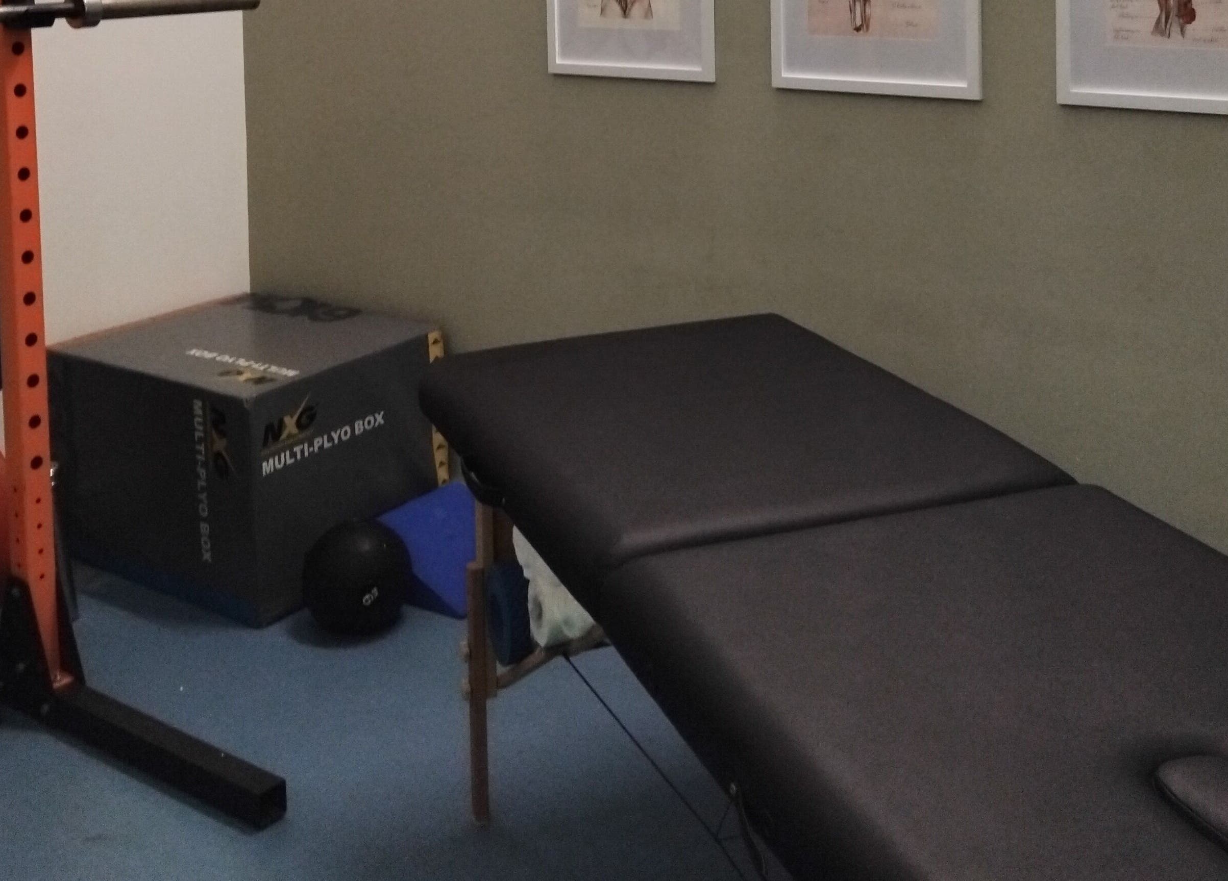Interior of Mode1 Fitness at Everlast Gyms Bangor in Northern Ireland, featuring gym equipment and a massage table.