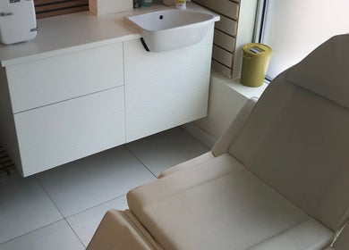 Calm treatment area at HTR Aesthetics, Bristol, England, GB with a comfortable chair and modern sink.