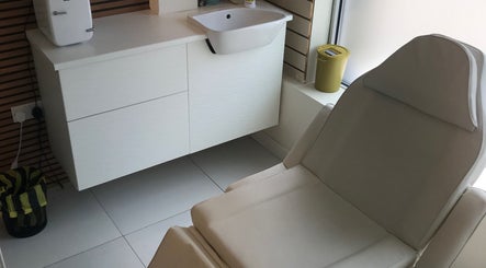 Calm treatment area at HTR Aesthetics, Bristol, England, GB with a comfortable chair and modern sink.